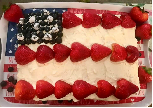 A traditional flag cake of a 13x9-inch yellow cake topped with frosting, then decorated with strawberries and blueberries, is the perfect ending to a special 4th of July dinner. Photo by Kara Kimbrough