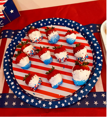 White chocolate (or in this case, marshmallow crème) dipped strawberries
decorated with sprinkles and
blue sugar makes the perfect patriotic
snack. Photo by Kara Kimbrough