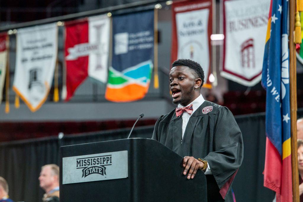 Mississippi State graduate Kirklyn Johnson leads the university alma mater during spring commencement in May. Diagnosed with non-verbal autism as toddlers, Kirklyn and his twin brother, Kirk, relied on music to overcome early learning barriers. Kirklyn earned his bachelor’s degree in music education, while Kirk continues in MSU’s ACCESS program, designed for college-age students with intellectual and developmental disabilities to receive a quality higher education experience. (Photo by Emily Grace McCall)