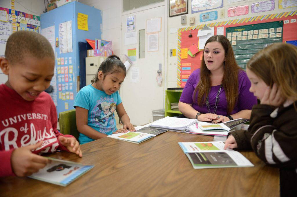 Jennifer Lee Williams (third from left), a senior elementary education major at the University of Mississippi, works with children on reading skills in Southaven Elementary School. The university's School of Education and Center for Excellence in Literacy Instruction worked with partners across the state to help boost literacy skills among elementary students. Photo by Kevin Bain/Ole Miss Digital Imaging Services