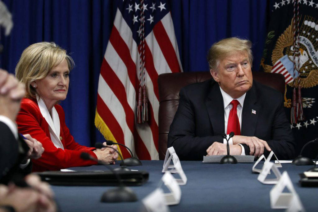 President Donald Trump listens during a roundtable discussion on the First Step Act, Monday, Nov. 26, 2018, in Gulfport, Miss. at left is Sen. Cindy Hyde-Smith, R-Miss. (AP Photo/Alex Brandon - Copyright 2018 The Associated Press. All rights reserved.)
