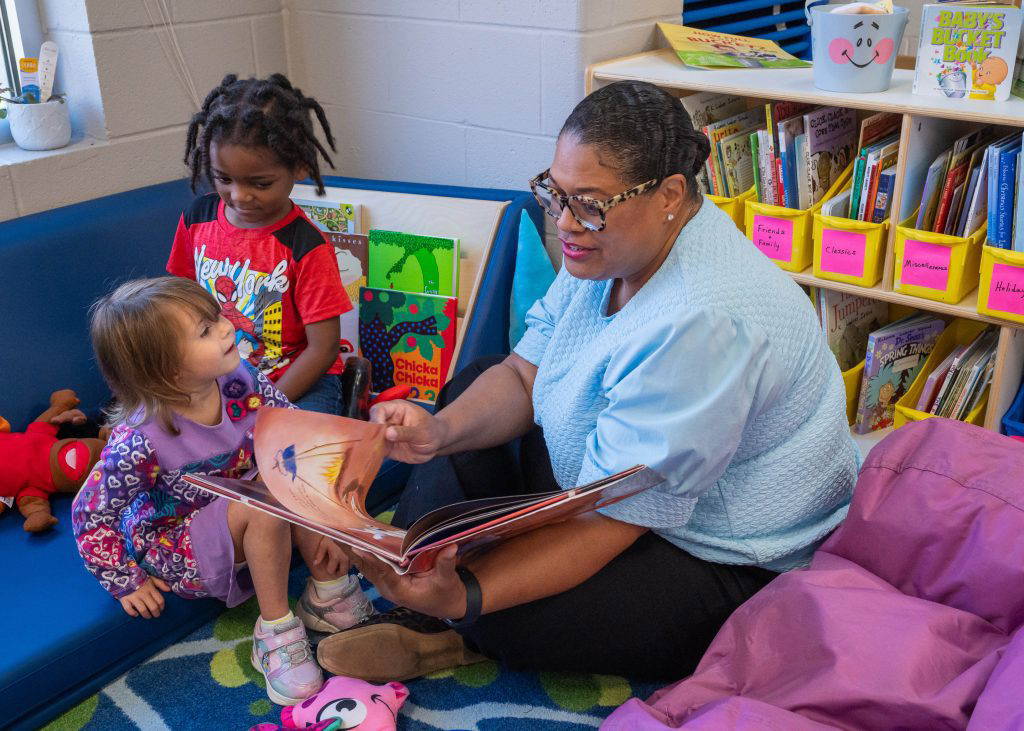 amila Taylor, executive director of Mississippi State University Extension Early Childhood Programs, reads a book to two students of the Hancock County Head Start during an event in April 2026. This year is MSU Extension Head Start’s seventh year of serving families in Harrison County and its second year of expanding services into Hancock County. (Photo by MSU Extension Service/Kevin Hudson)