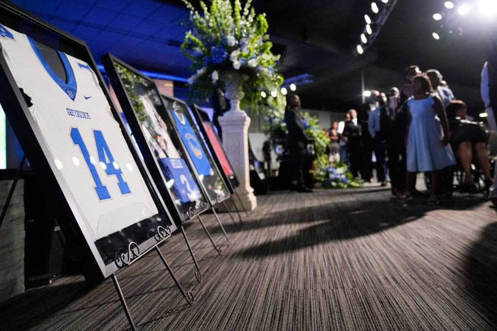 Sports jerseys are framed during a memorial service for Nolan Xavier Wells, an 18-year-old found dead after taking a July 4 boat trip with friends, Monday, July 20, 2026, in Ocean Springs, Miss. (AP Photo/Gerald Herbert)